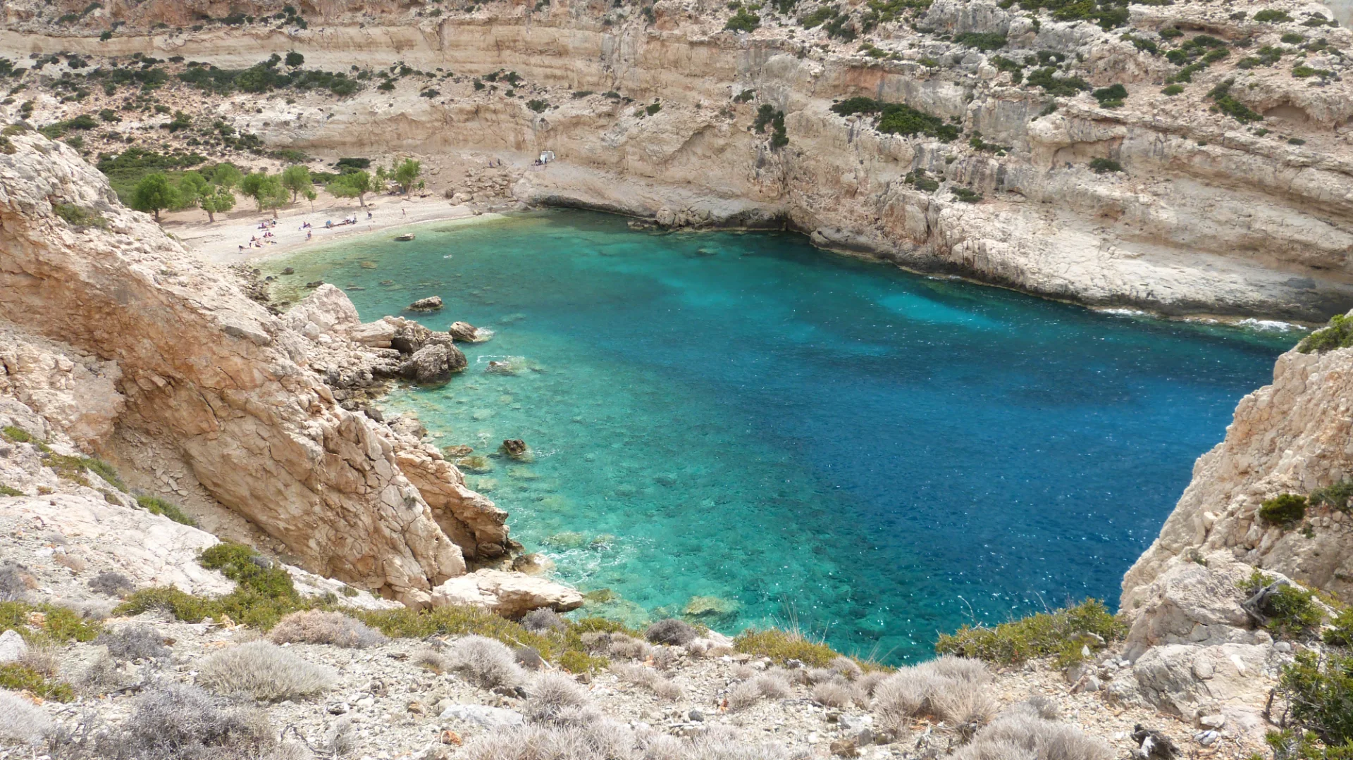 Remote beach at the end of Martsalo Gorge with rocky slopes and clear water