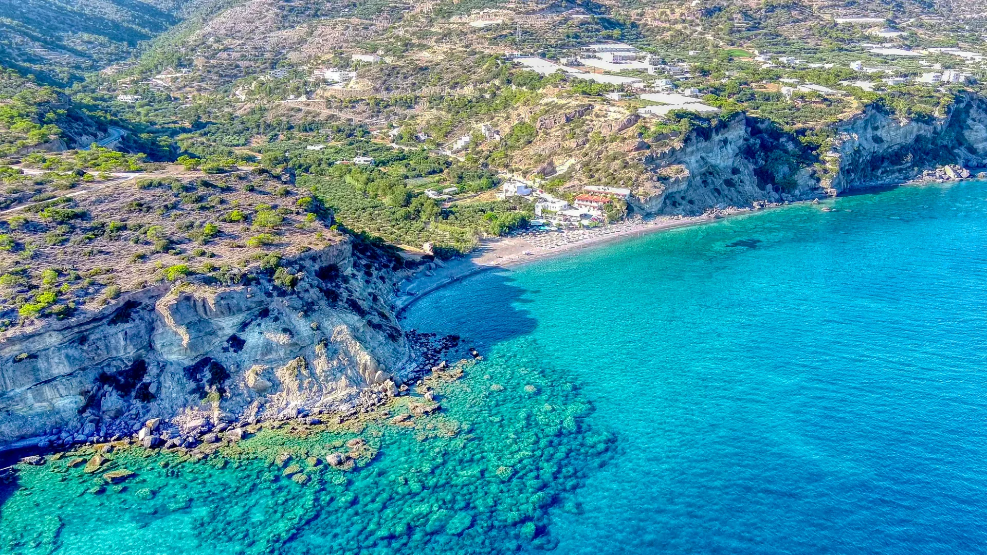 Aerial view of Agia Fotia Beach near Ierapetra with turquoise water and a rocky coastline