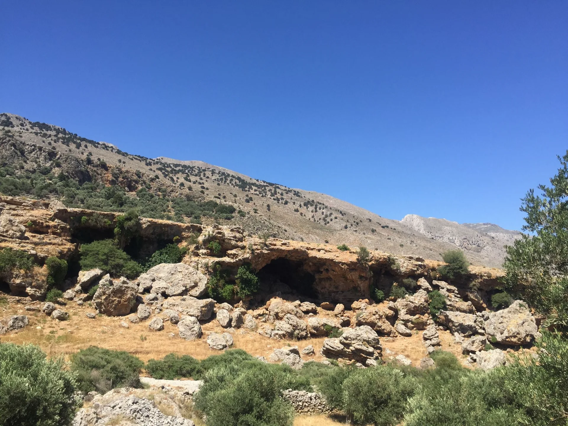 Rocky mountain landscape in Imbros Gorge with sparse vegetation and blue sky
