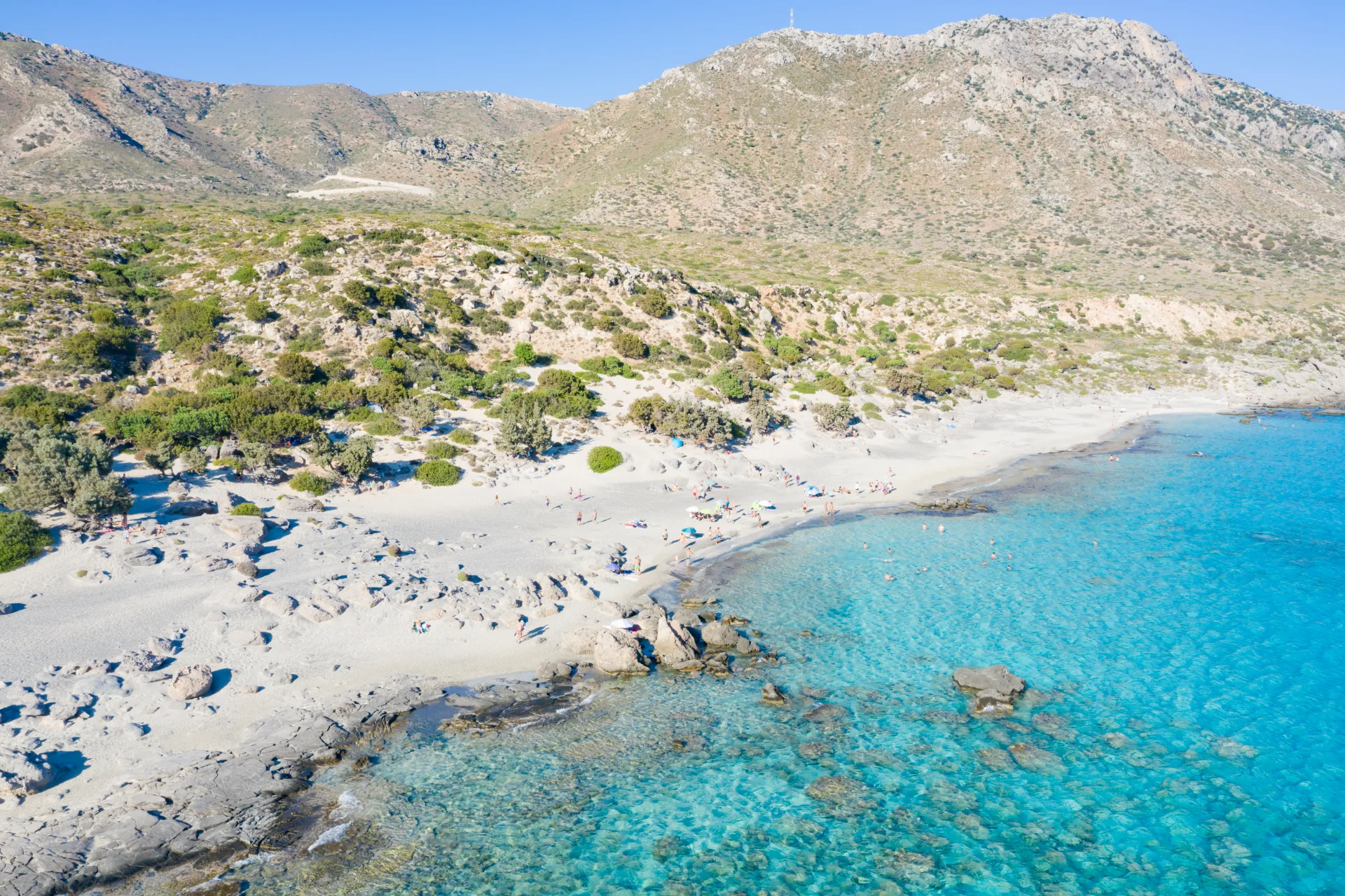Aerial view of Kedrodasos with pale shoreline, junipers and clear water