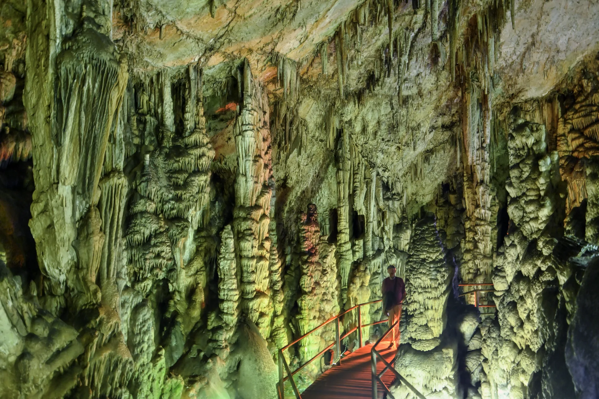 Interior of Dikteon Cave with rock formations and the illuminated visitor walkway
