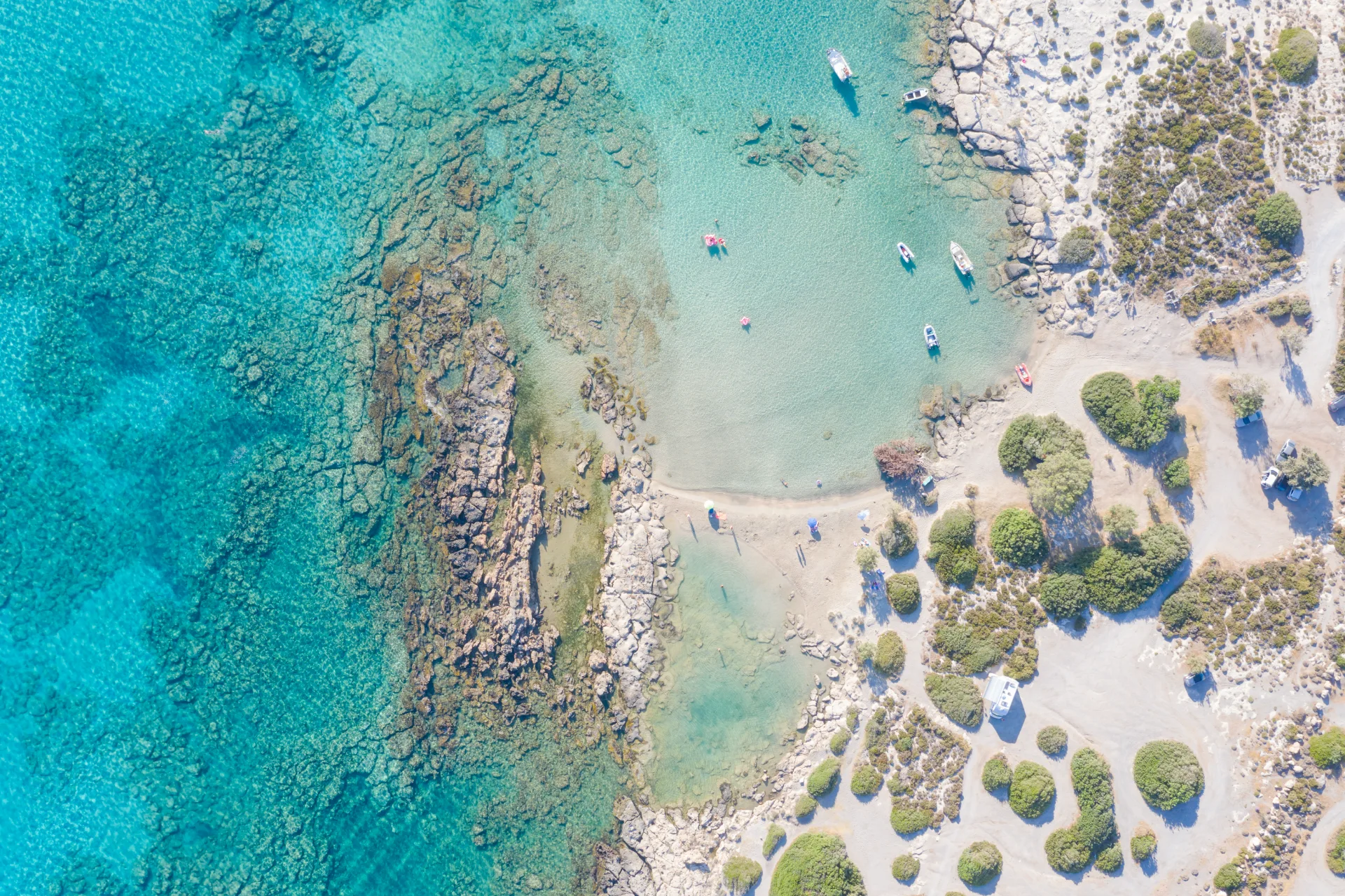 Top-down aerial view of Elafonissi with shallow turquoise water and pale shoreline
